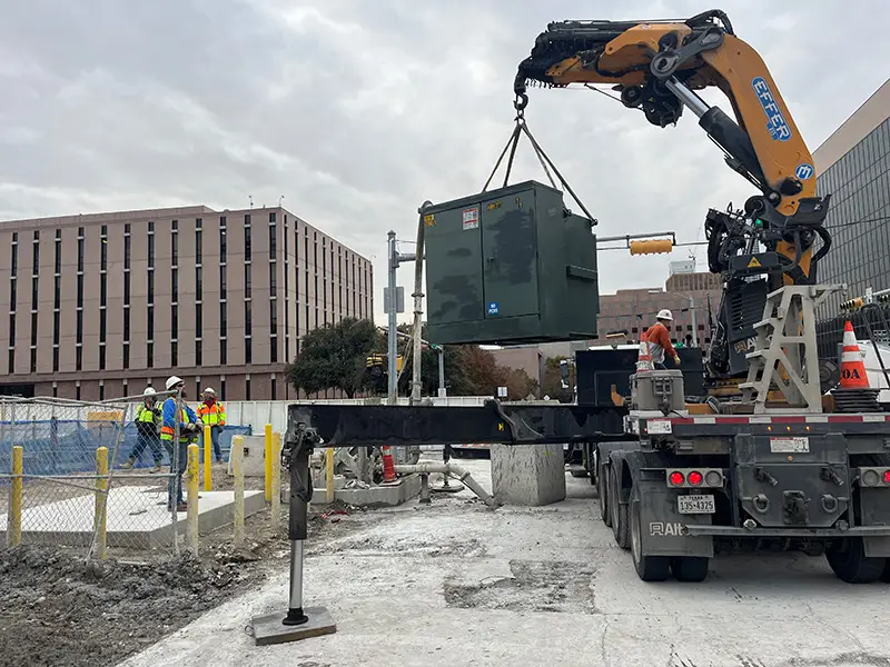 Crane setting a transformer on Phase II of the Capitol Complex Project, 2025.