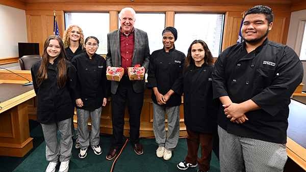 Novak receives holiday cookies from the students of the School for the Deaf's Culinary Academy.