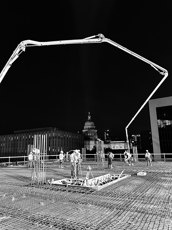 April 2025 - View of the Capitol in the background during a 1500 Lavaca State Office Building project concrete pour.