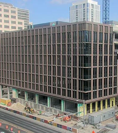 The 1501 Lavaca State Office Building with Sunset Red granite curtain wall installed.