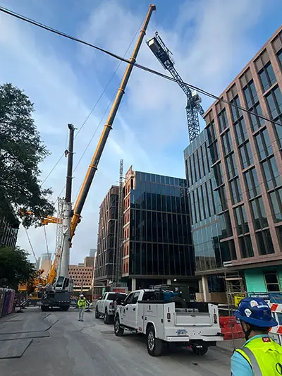 Counterweight of the tower crane being hooked up to fly to the ground.