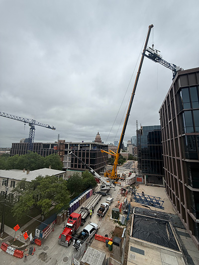 Mobile Crane loading pieces of the tower crane's jib onto semi-trucks.