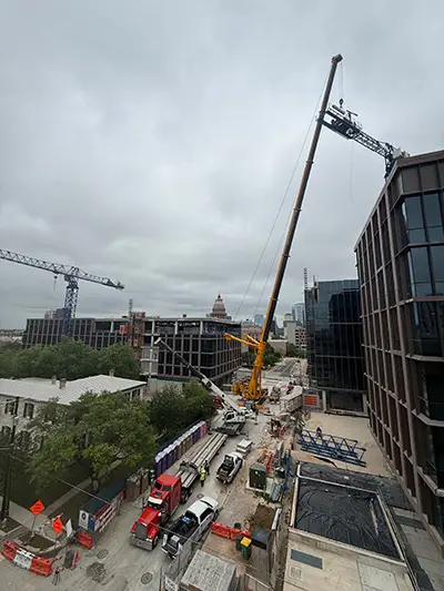Mobile Crane loading pieces of the tower crane's jib onto semi-trucks.